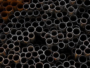 A pile of metal pipes stacked on top of each other