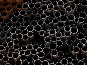 A pile of metal pipes stacked on top of each other