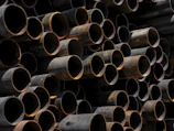 A large stack of pipes stacked on top of each other
