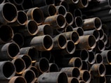 A large stack of pipes stacked on top of each other