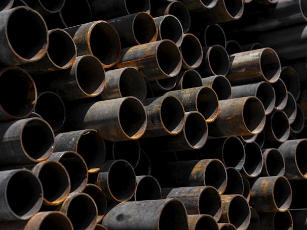 A large stack of pipes stacked on top of each other