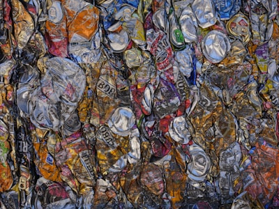 A large amount of soda cans are stacked together