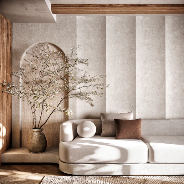 A living room with a white couch and a vase of flowers