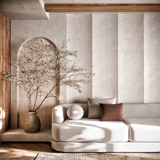 A living room with a white couch and a vase of flowers