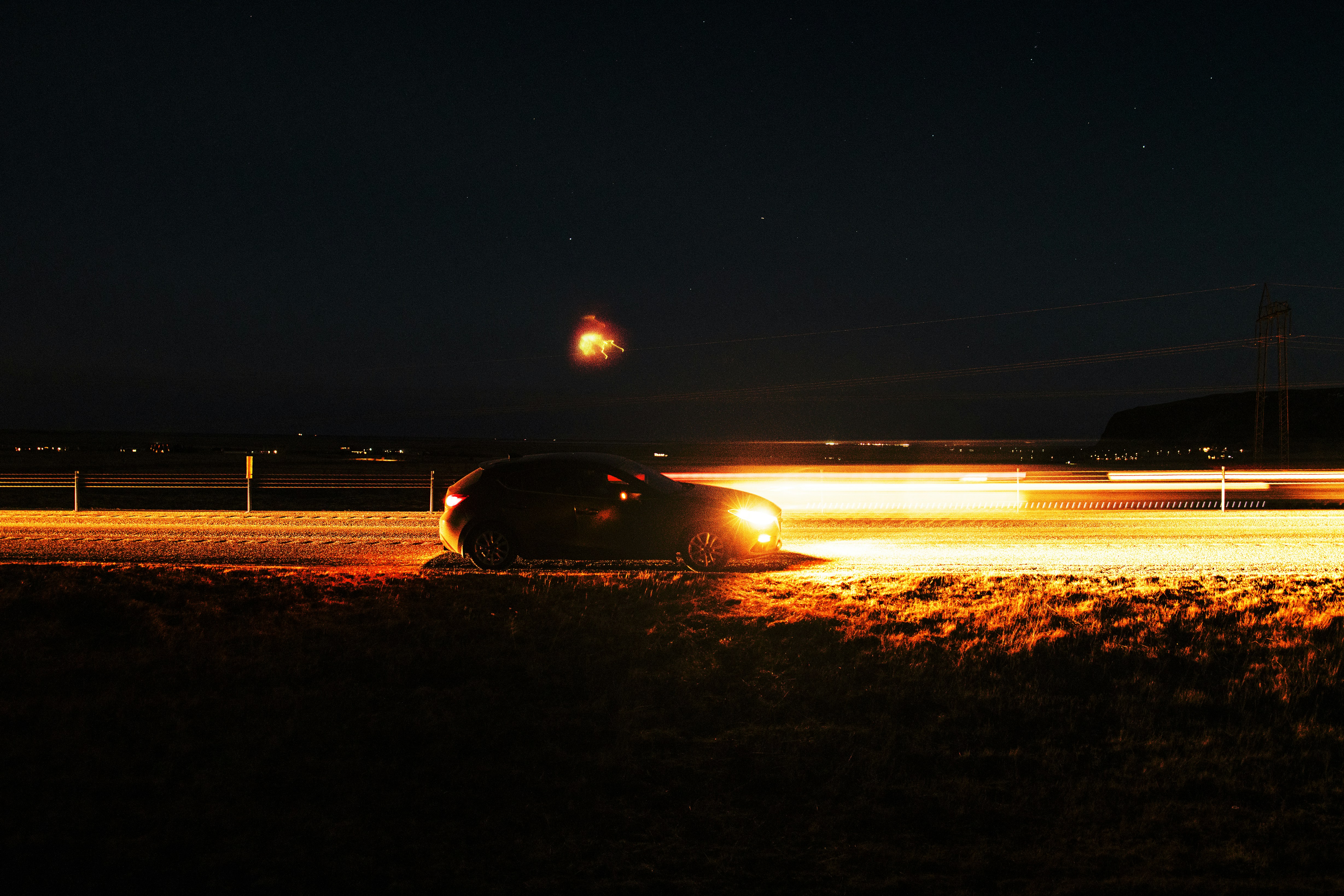 Ford F-150 Lightning electric truck towing a trailer on the highway