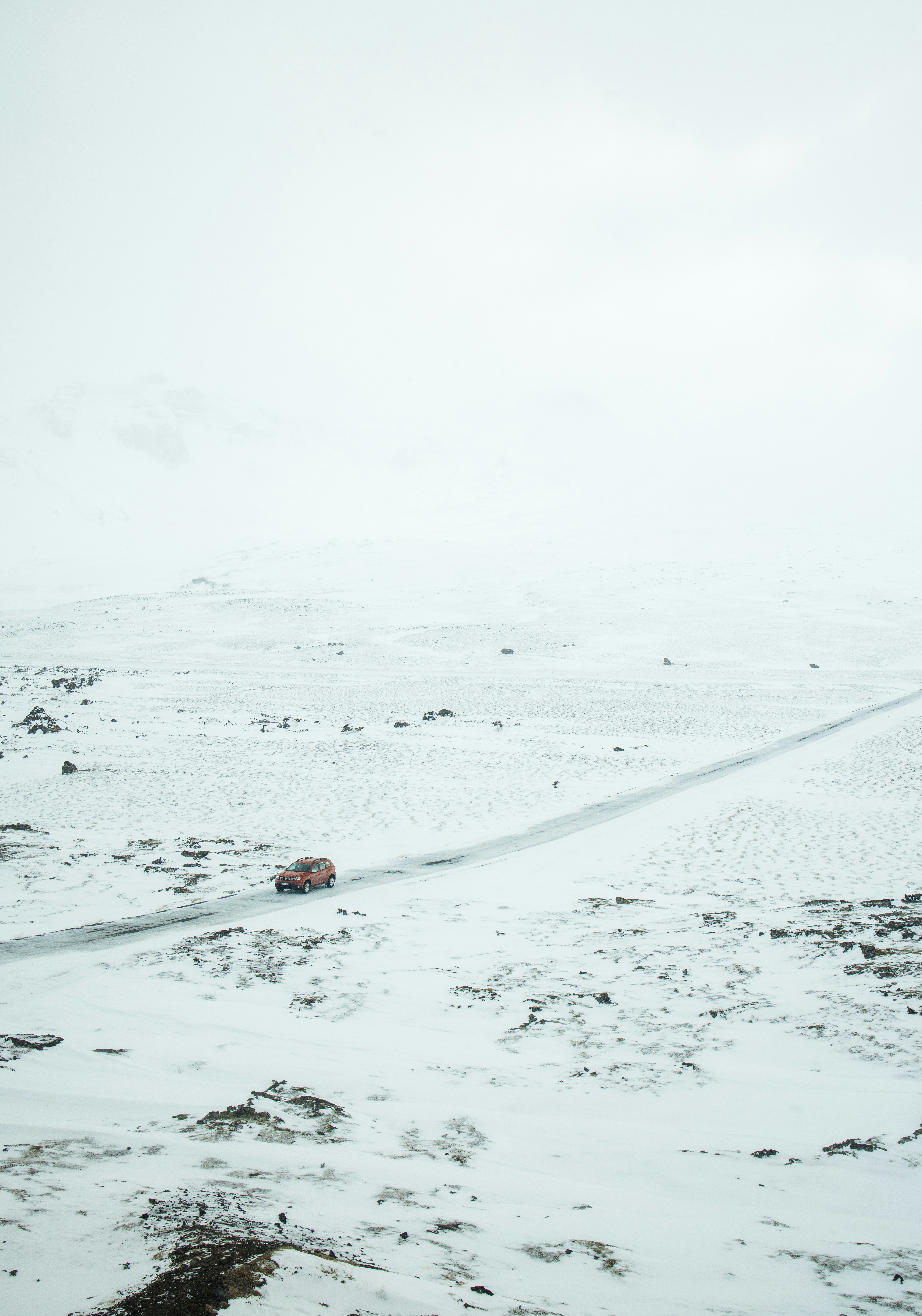 A car driving through a snowy field