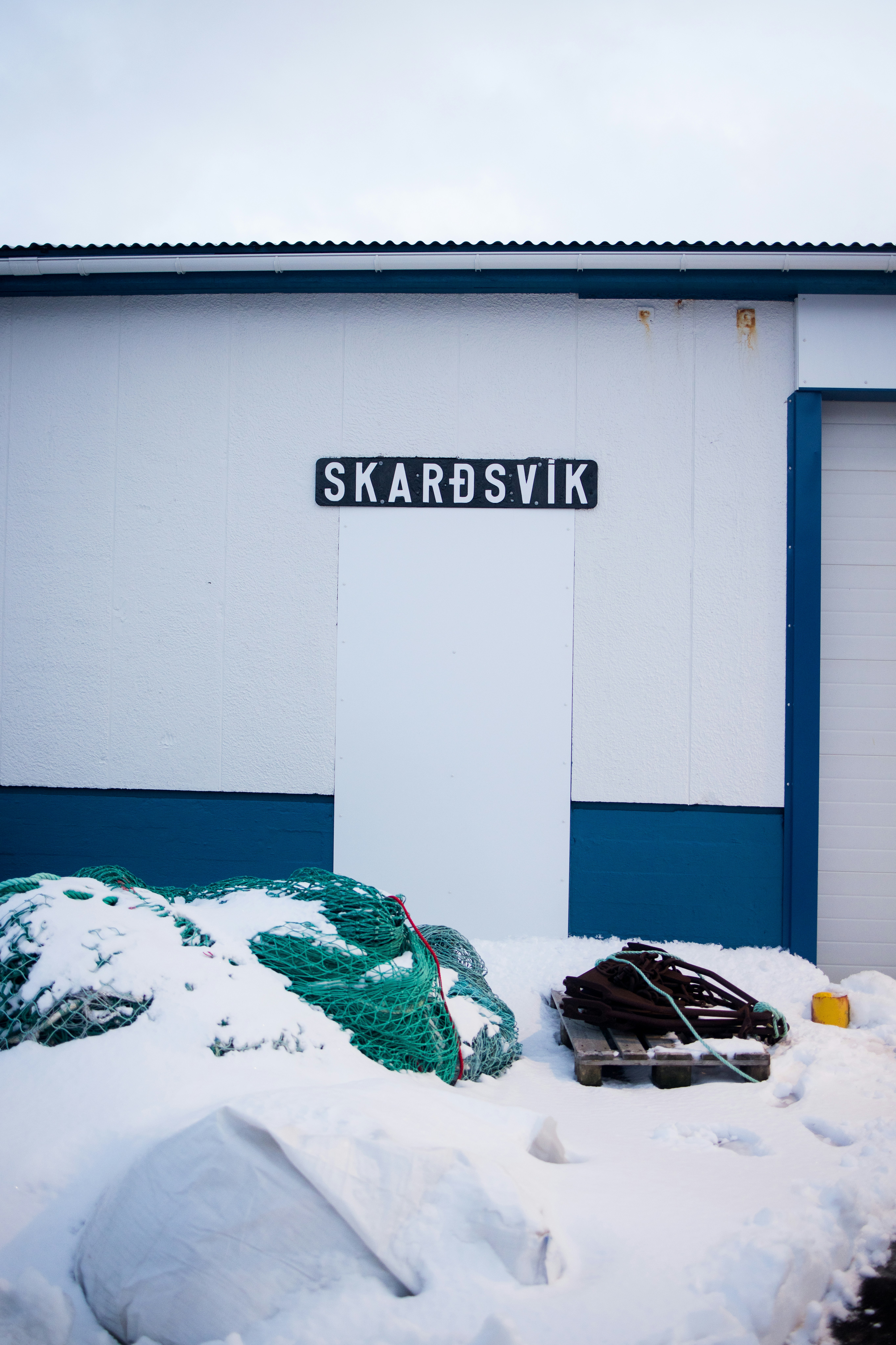 A snow covered parking lot next to a building