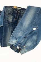 Three pairs of jeans sitting next to each other