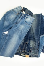 A pile of jeans laying on top of each other