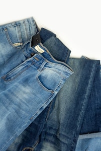 A pair of jeans laying on top of each other