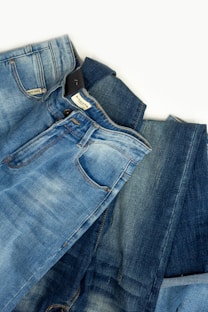 A pair of jeans laying on top of each other