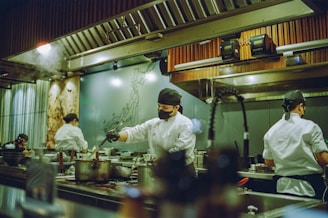 A group of chefs preparing food in a kitchen