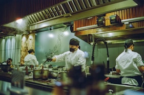 A group of chefs preparing food in a kitchen