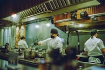 A group of chefs preparing food in a kitchen