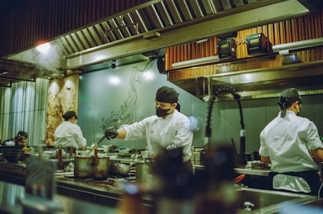 A group of chefs preparing food in a kitchen
