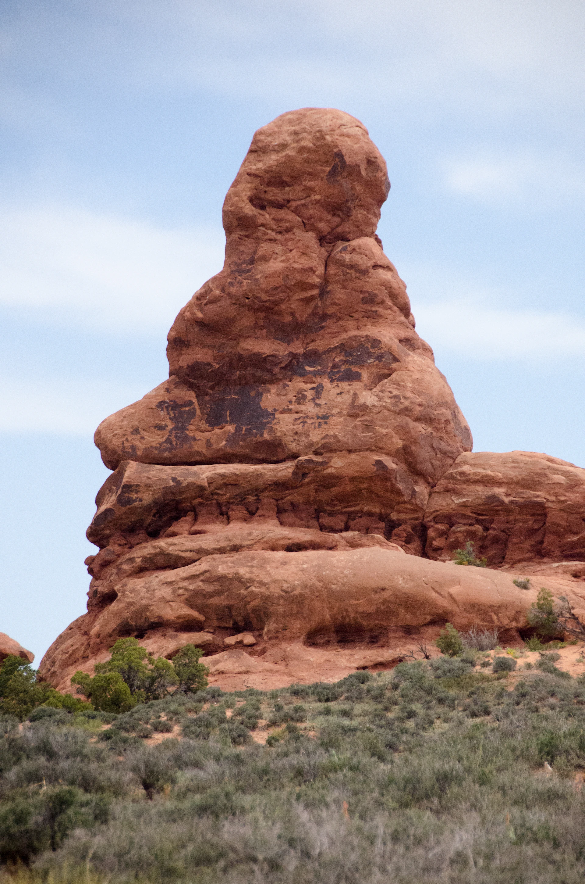 A large rock formation in the middle of a desert