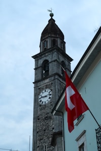 A tall clock tower with a clock on each of it's sides
