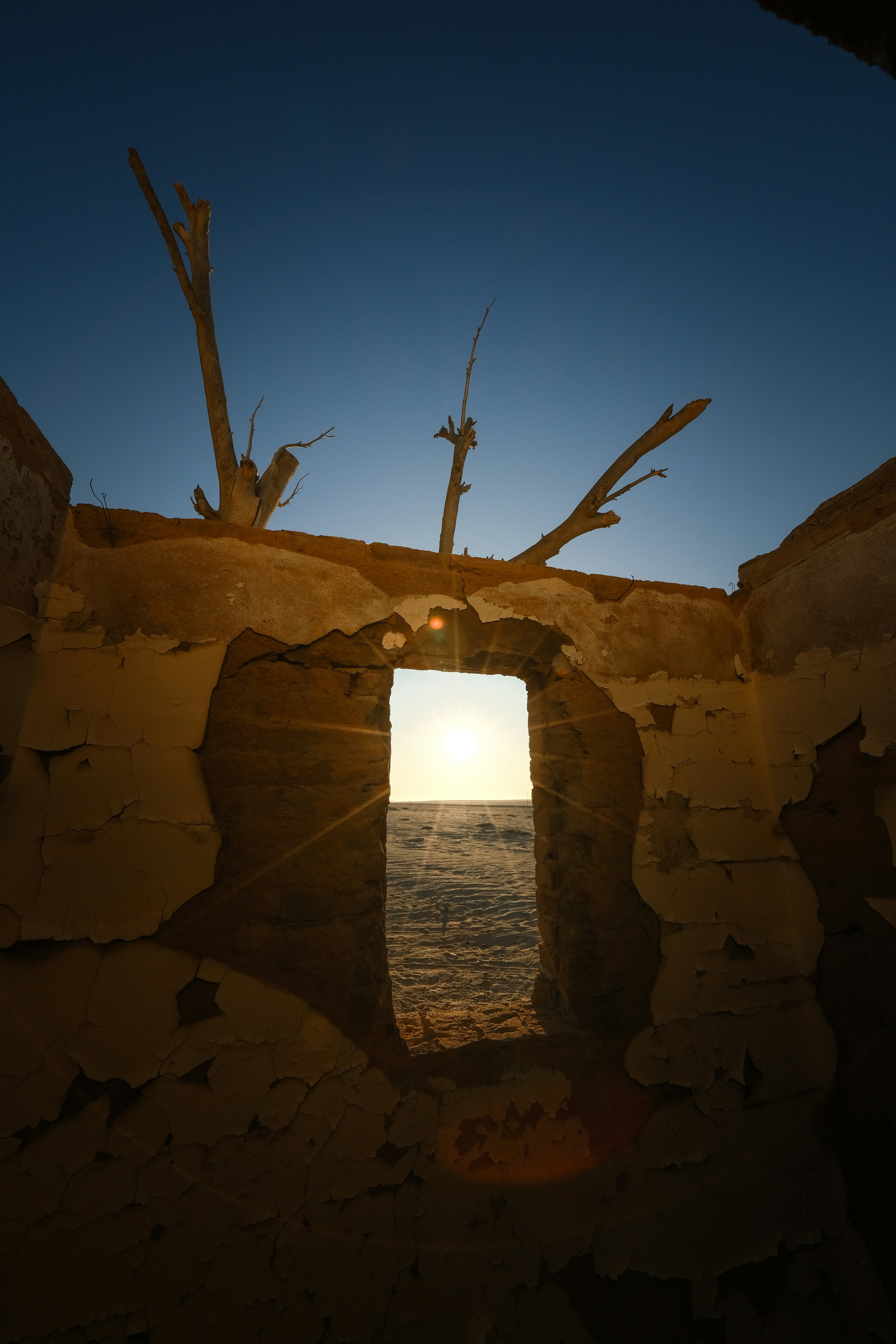 A view of the ocean through a hole in a wall