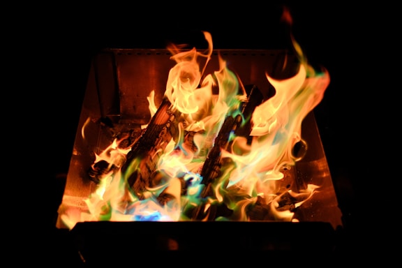 A fire burning in the dark with a black background
