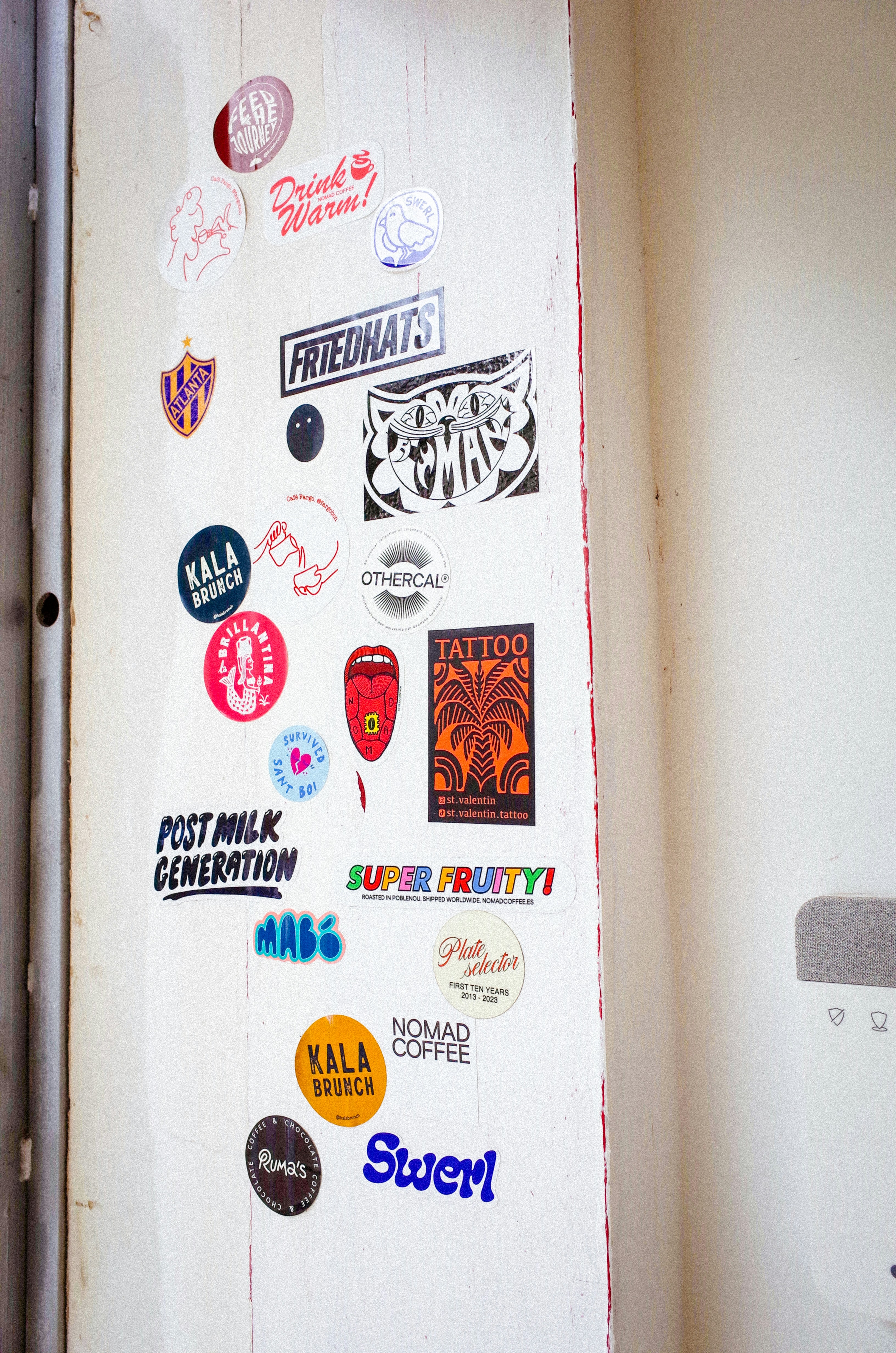 Colourful promotional stickers arranged in a grid pattern on a white background