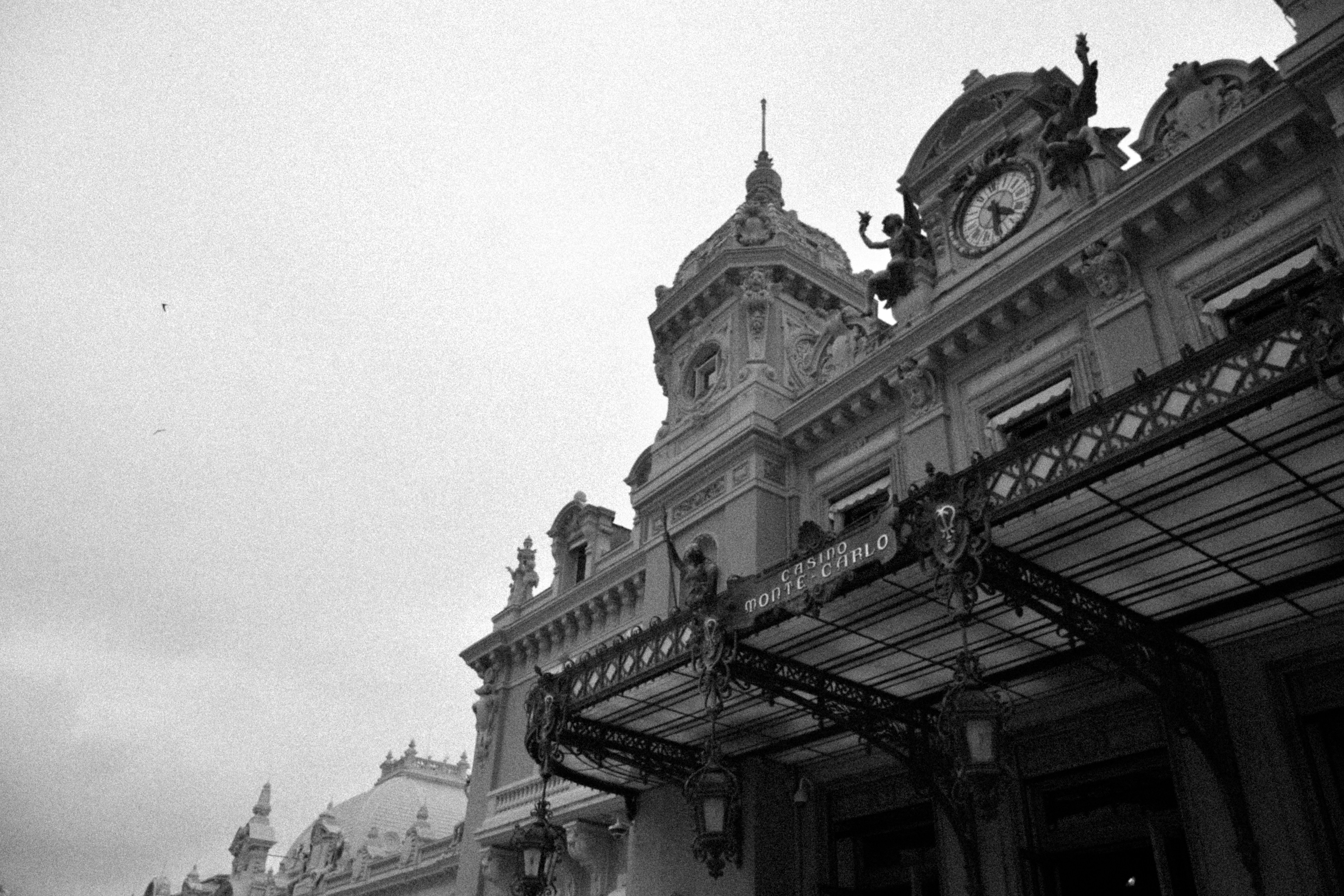A black and white photo of a building with a clock tower