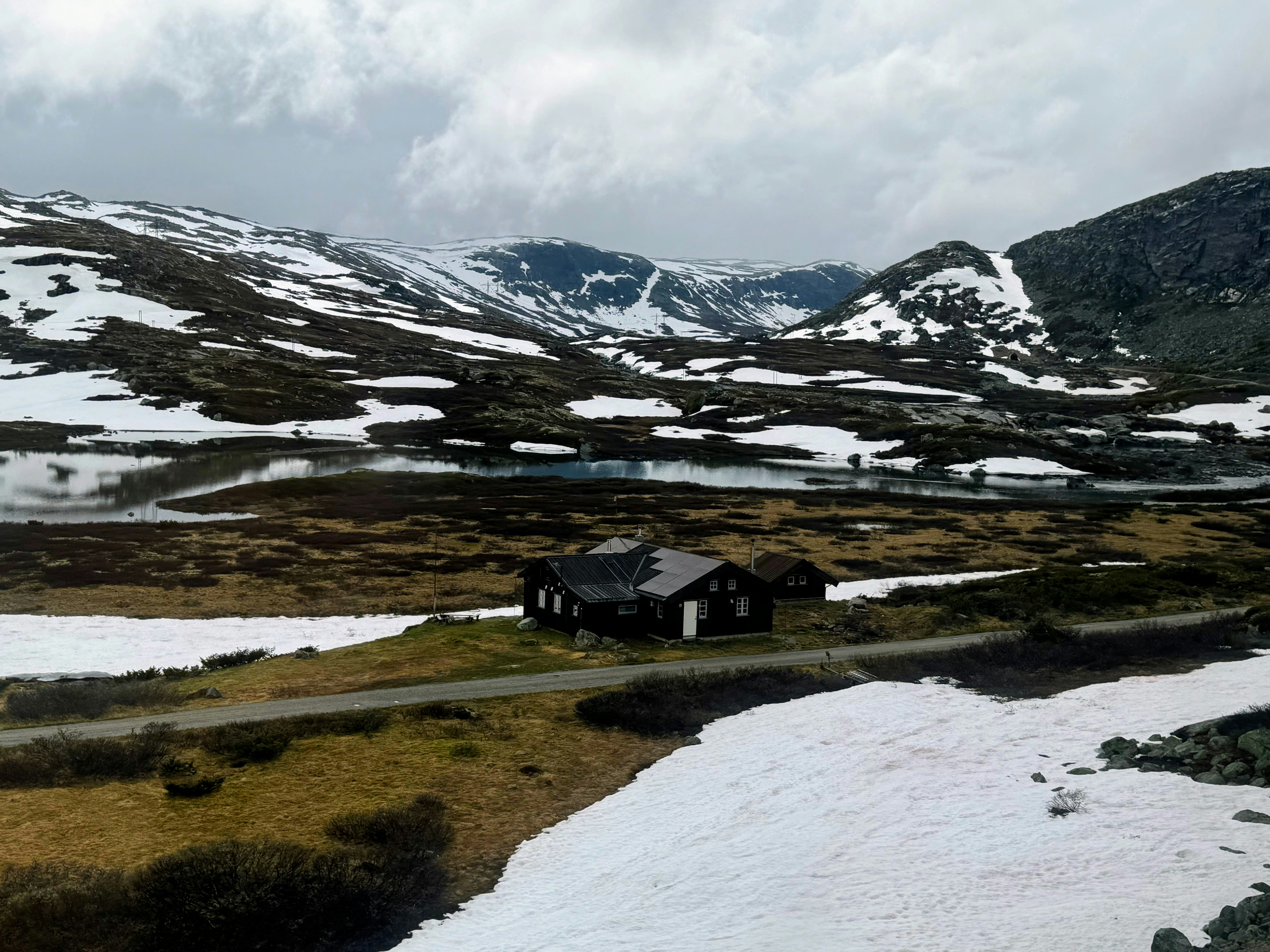 A house in the middle of a snowy field