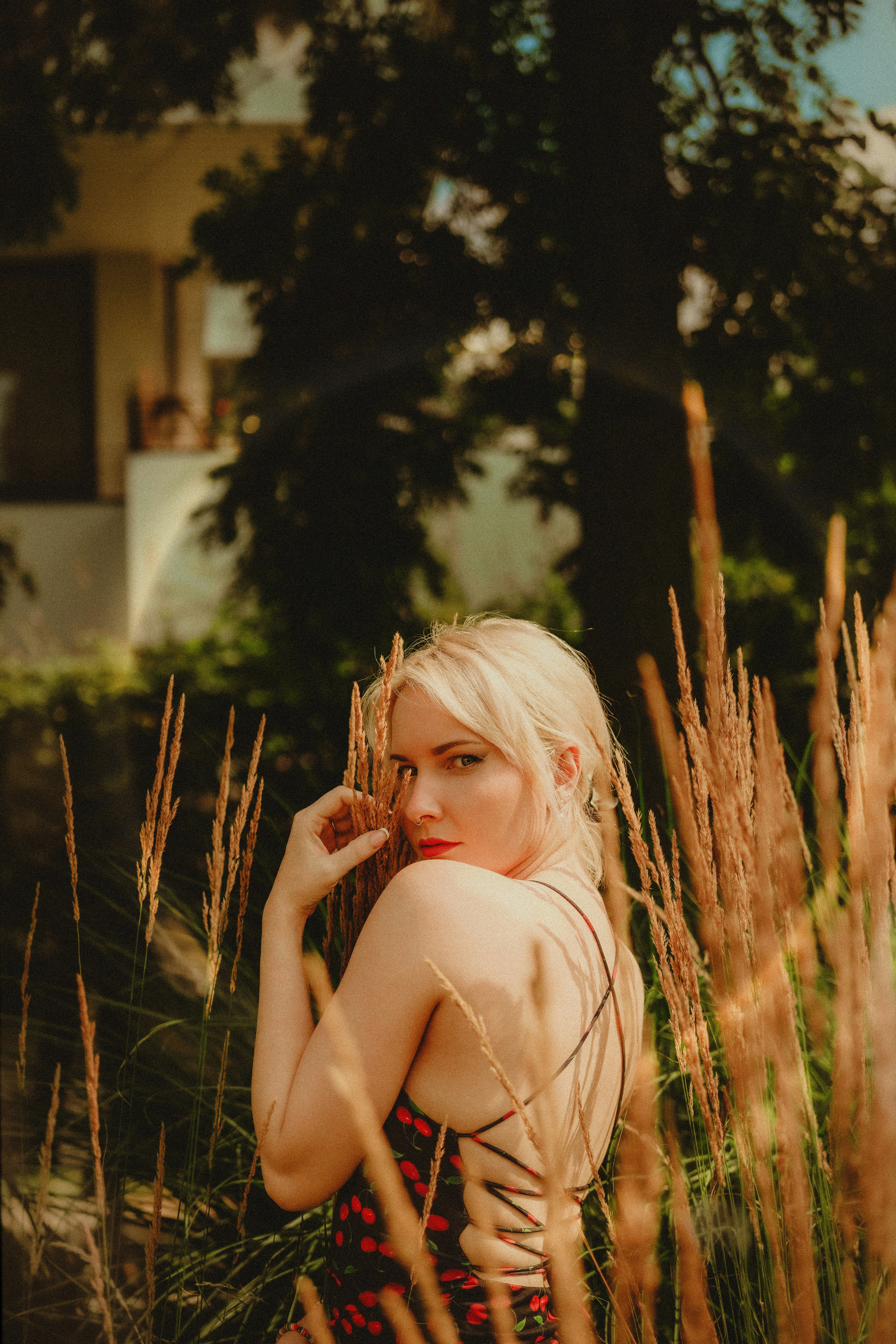A woman standing in a field of tall grass