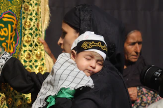 A man holding a small child in his arms