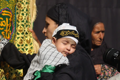 A man holding a small child in his arms