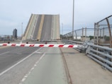 A large bridge with a red and white striped barrier