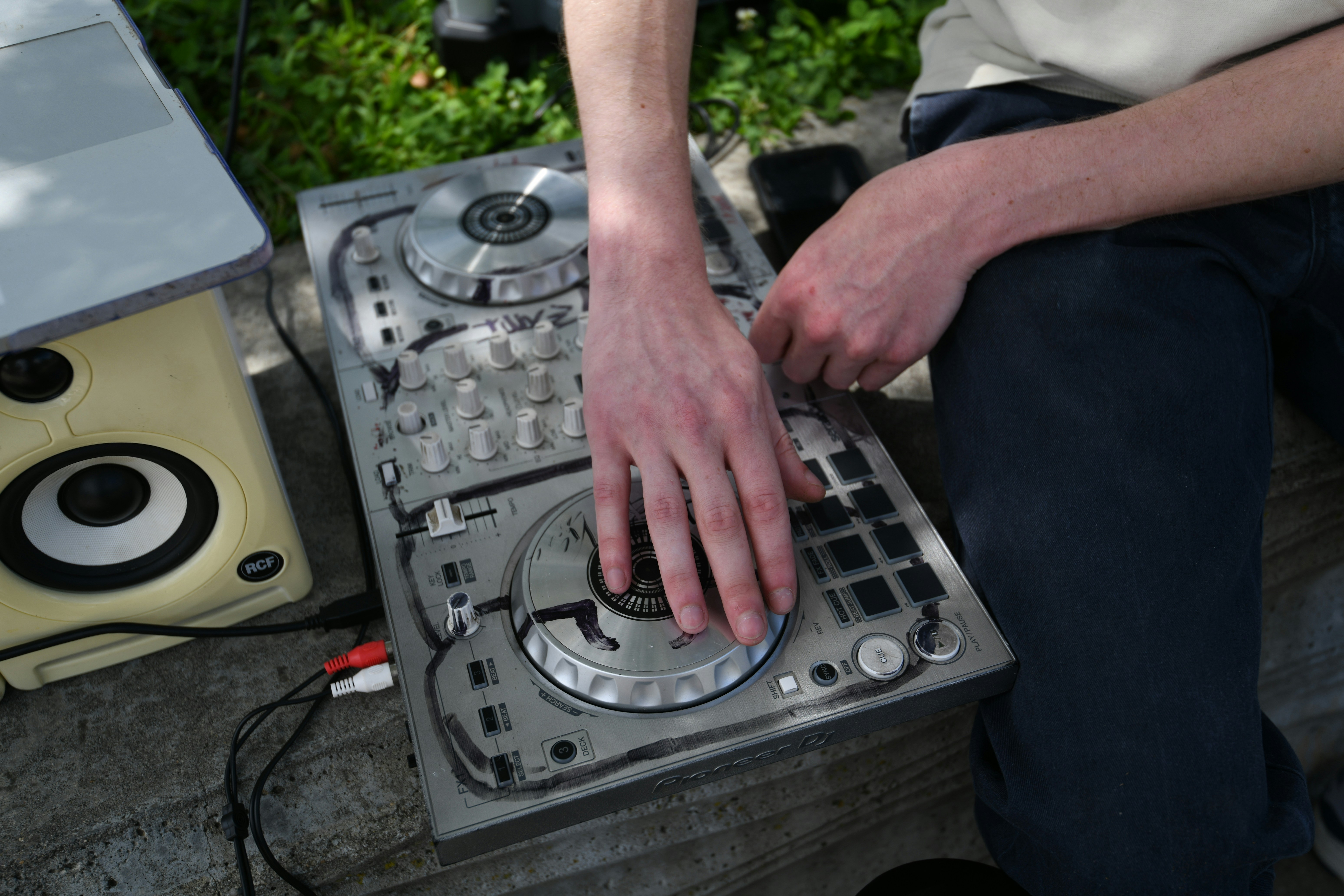 A man sitting on top of a metal box
