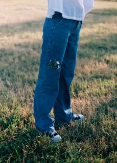 A person standing in a field holding a frisbee