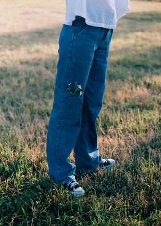 A person standing in a field holding a frisbee
