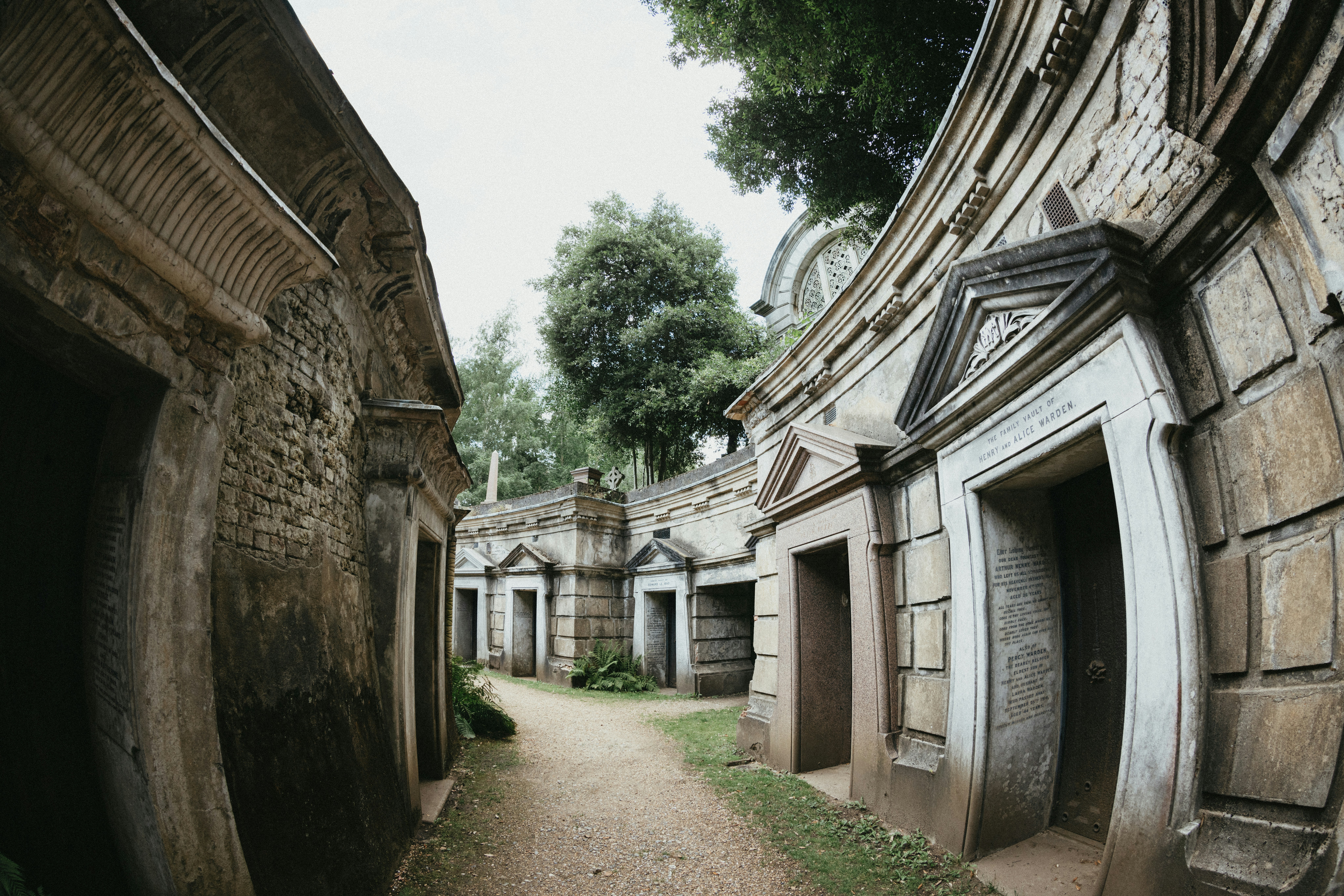 A narrow street with a bunch of buildings on either side of it