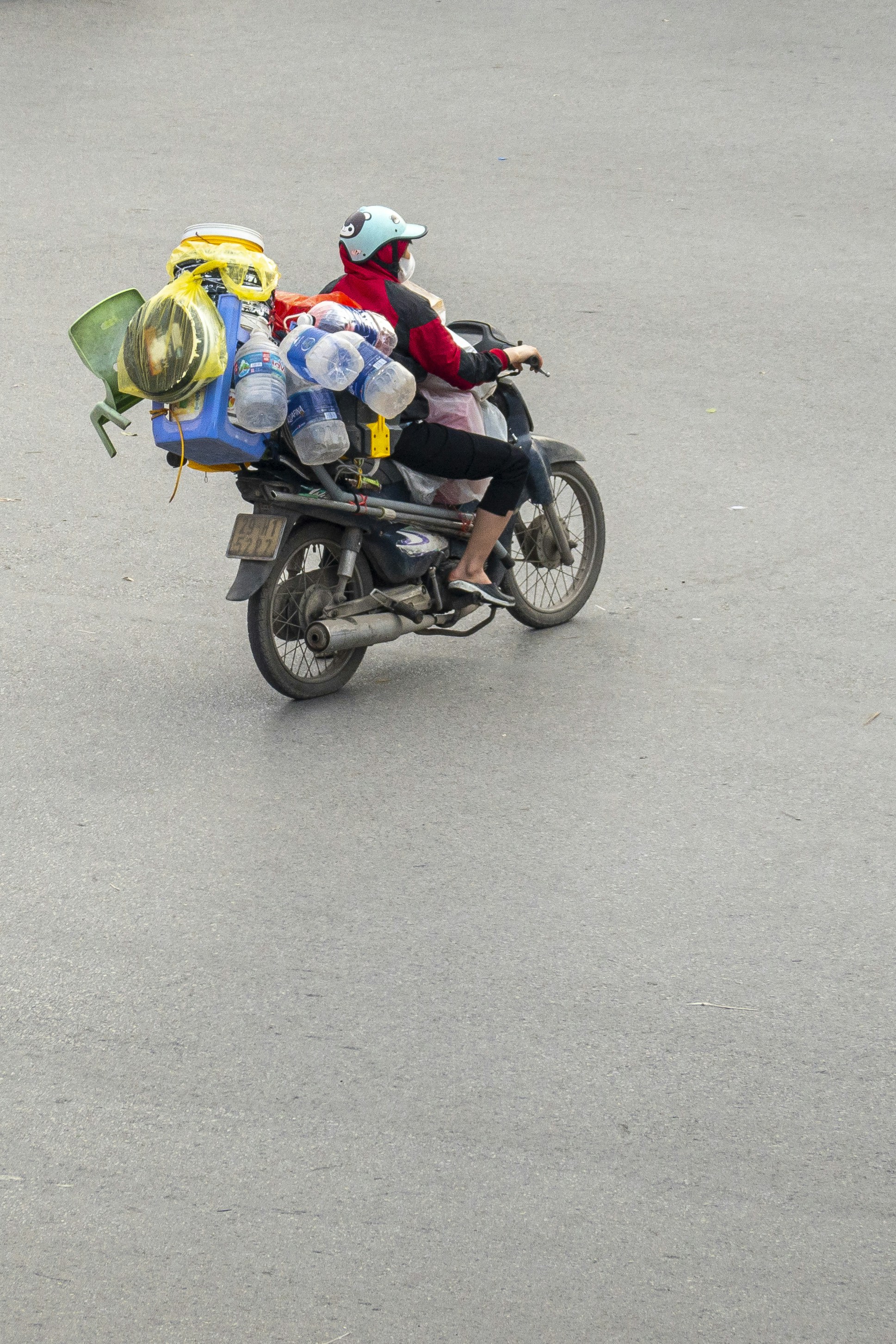 A man riding a motorcycle with a bunch of luggage on the back of it