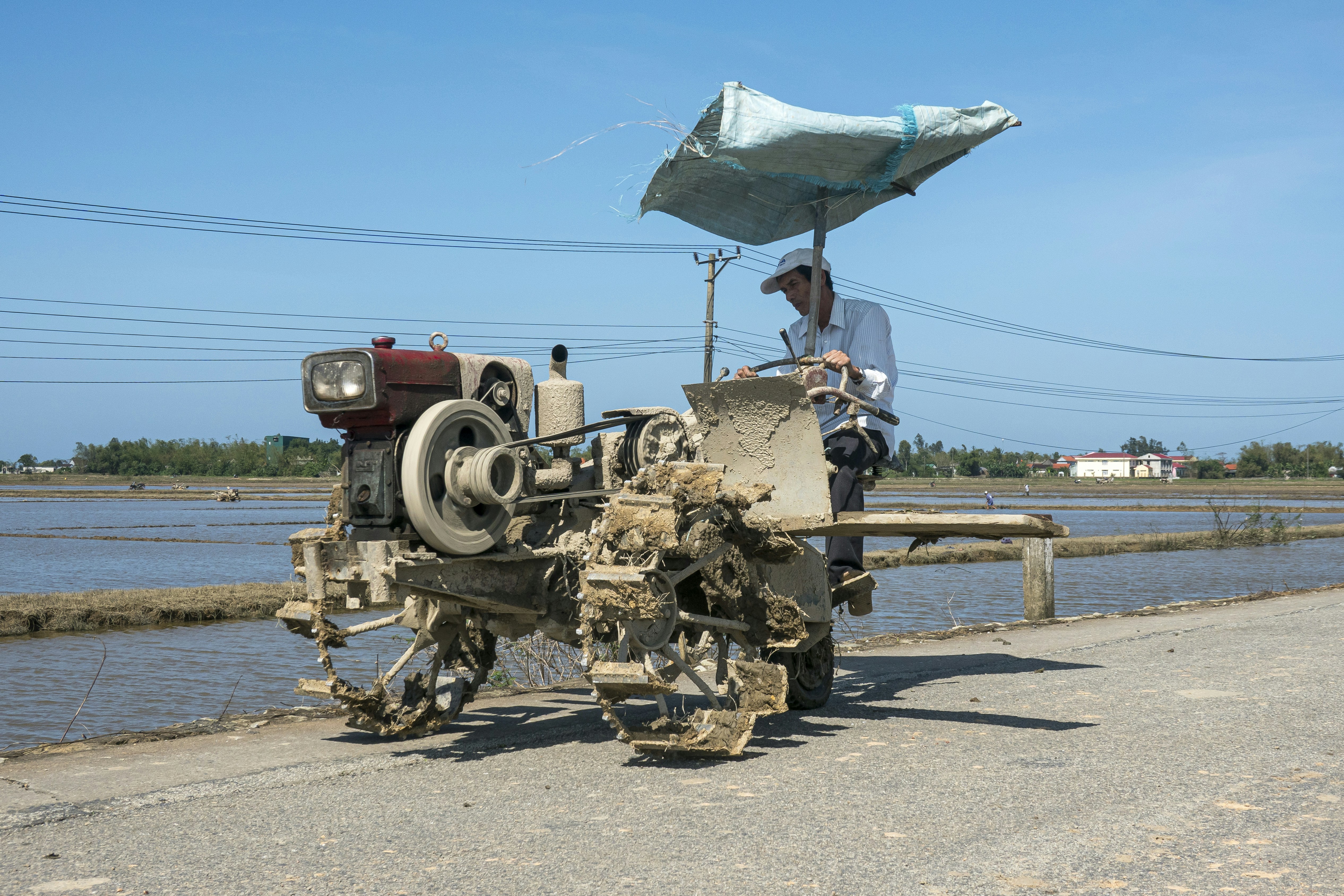 A man sitting on top of a machine next to a body of water