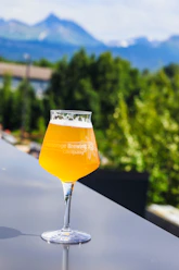 A glass of beer sitting on top of a table