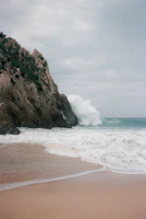 A beach with a wave coming in to the shore