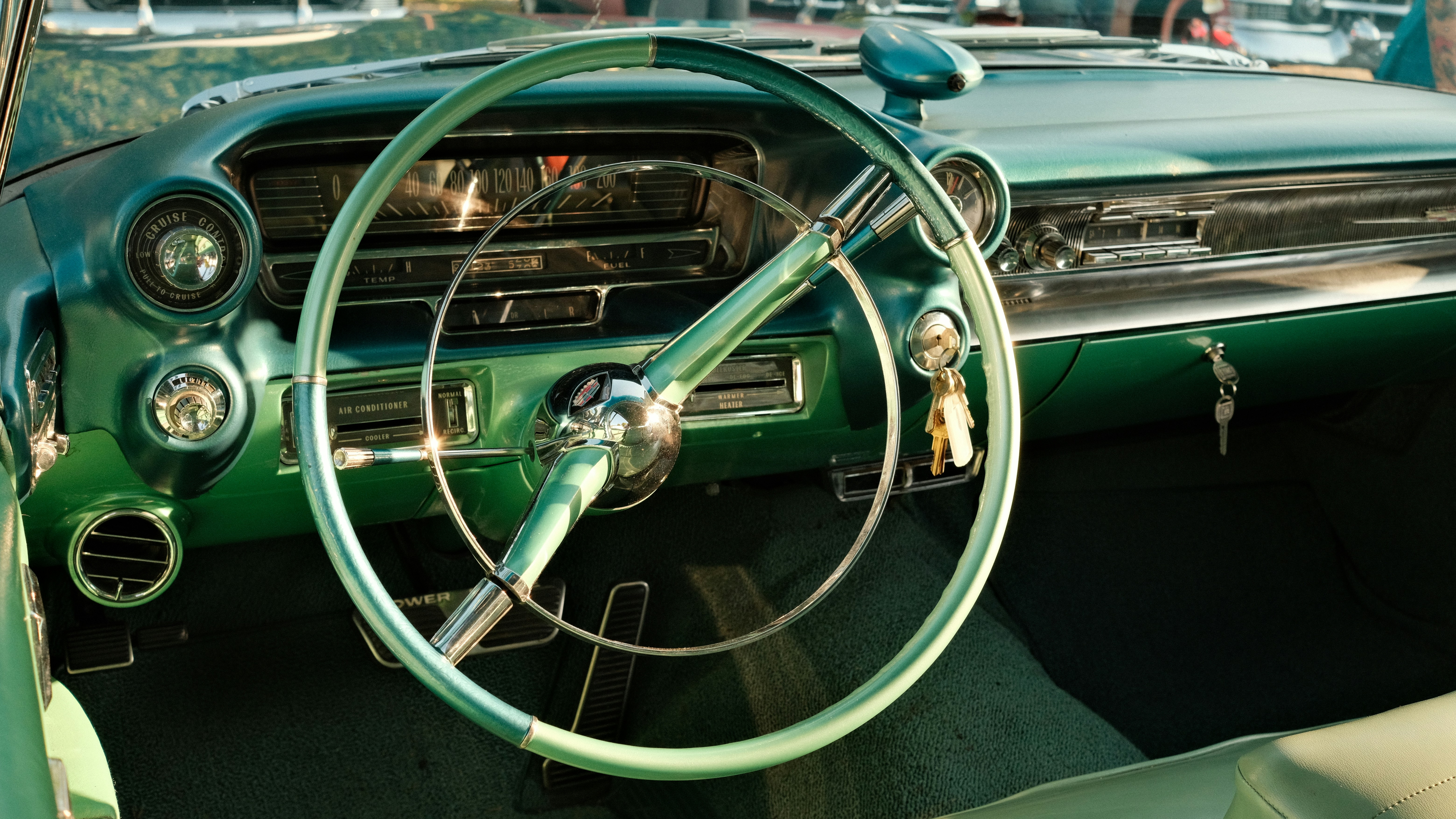 A green car with a steering wheel and dashboard