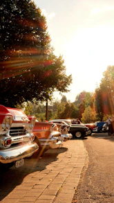 A row of classic cars parked next to each other