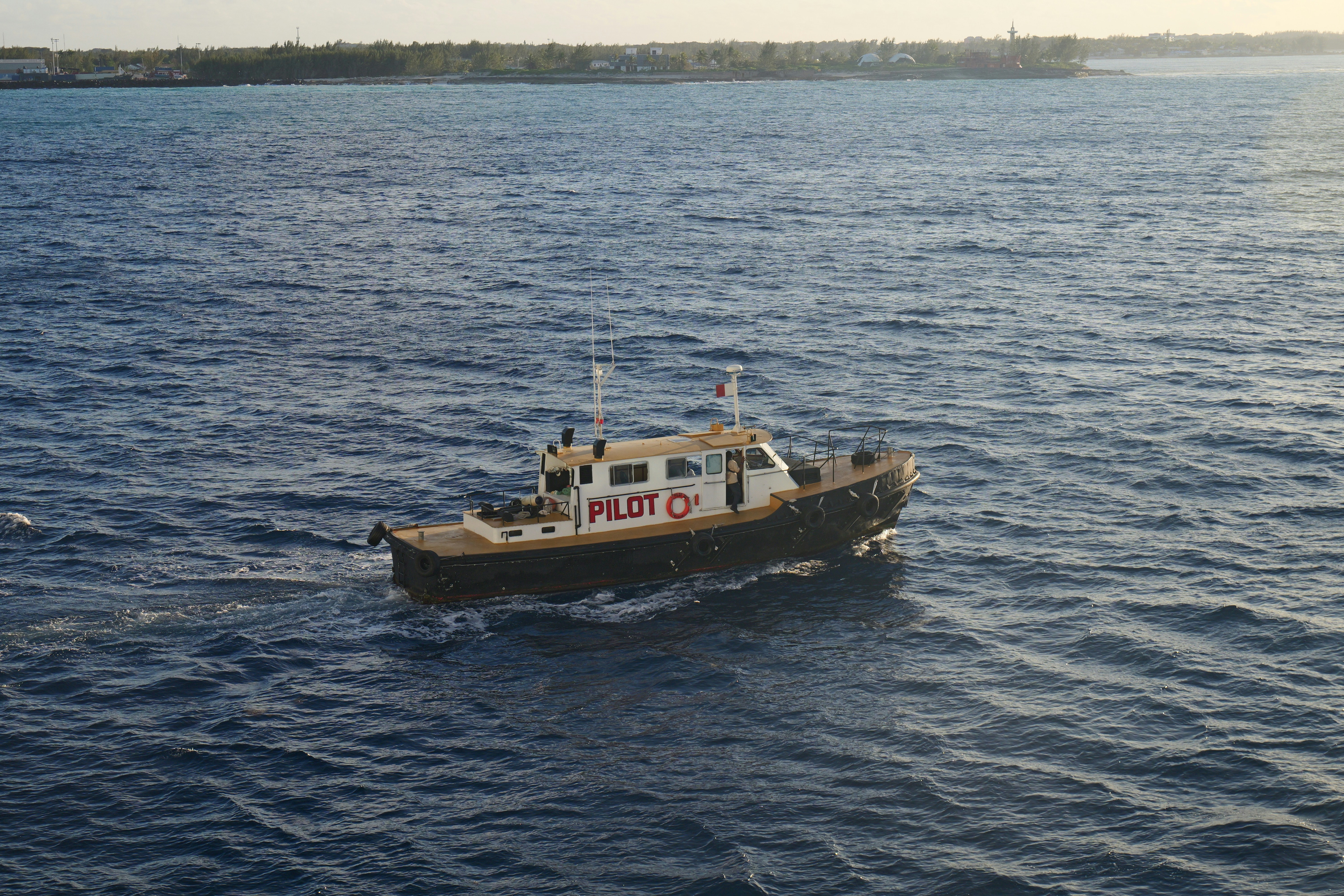 A small boat traveling across a large body of water