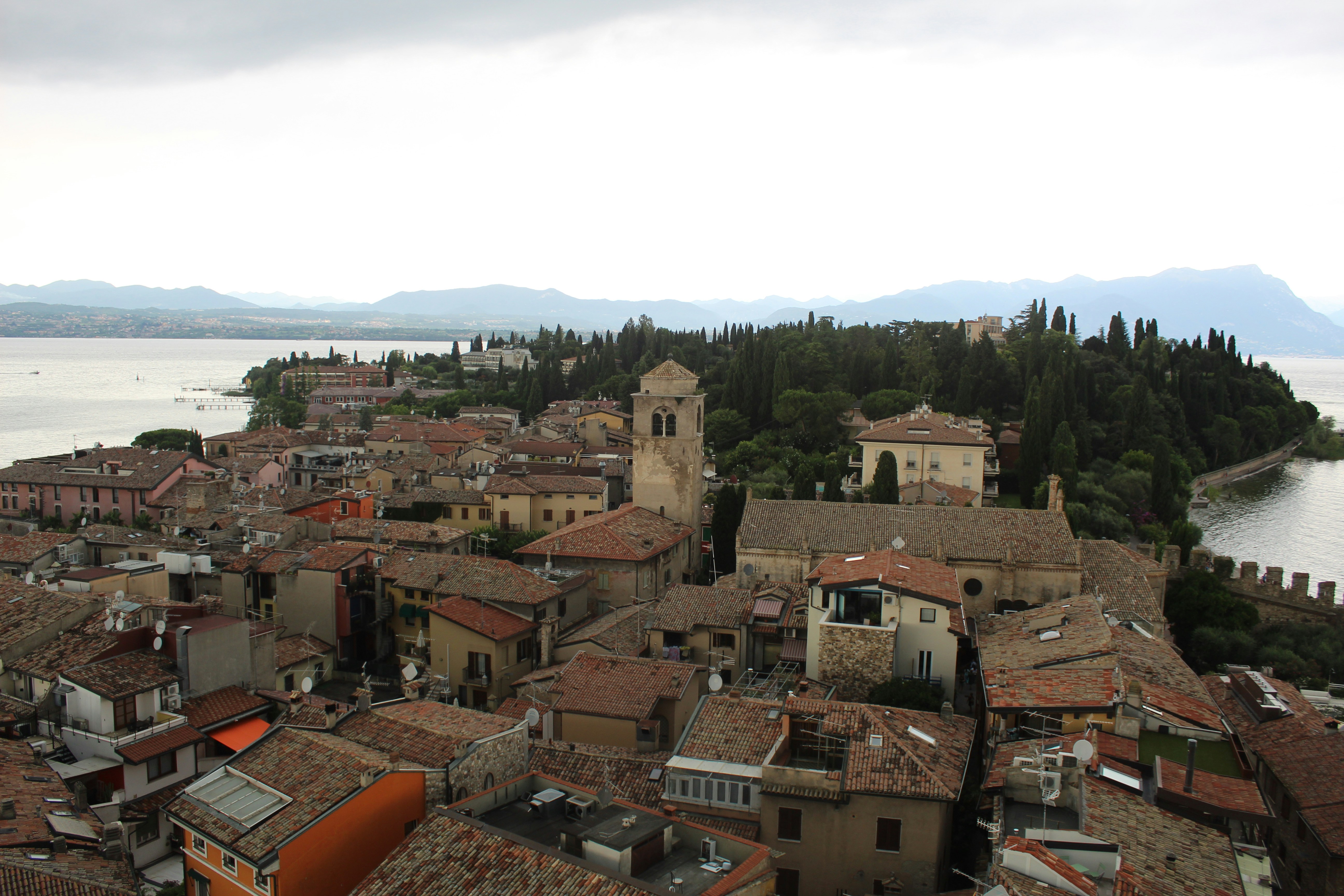 An aerial view of a city with a body of water in the background