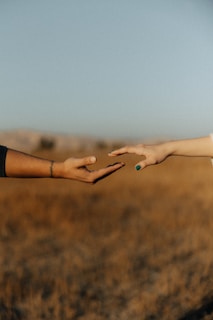 Two people reaching out their hands to each other