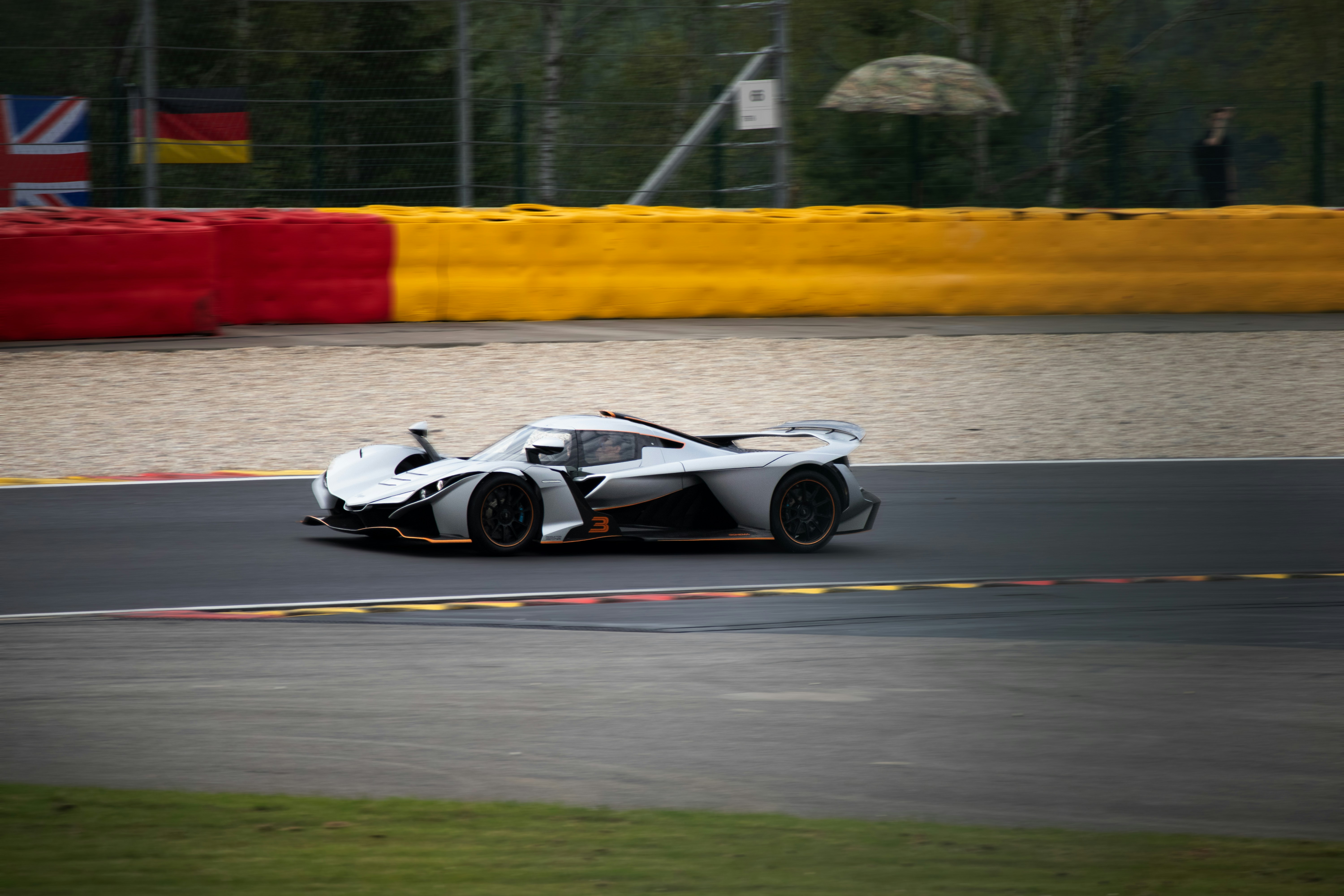 A white race car driving down a race track