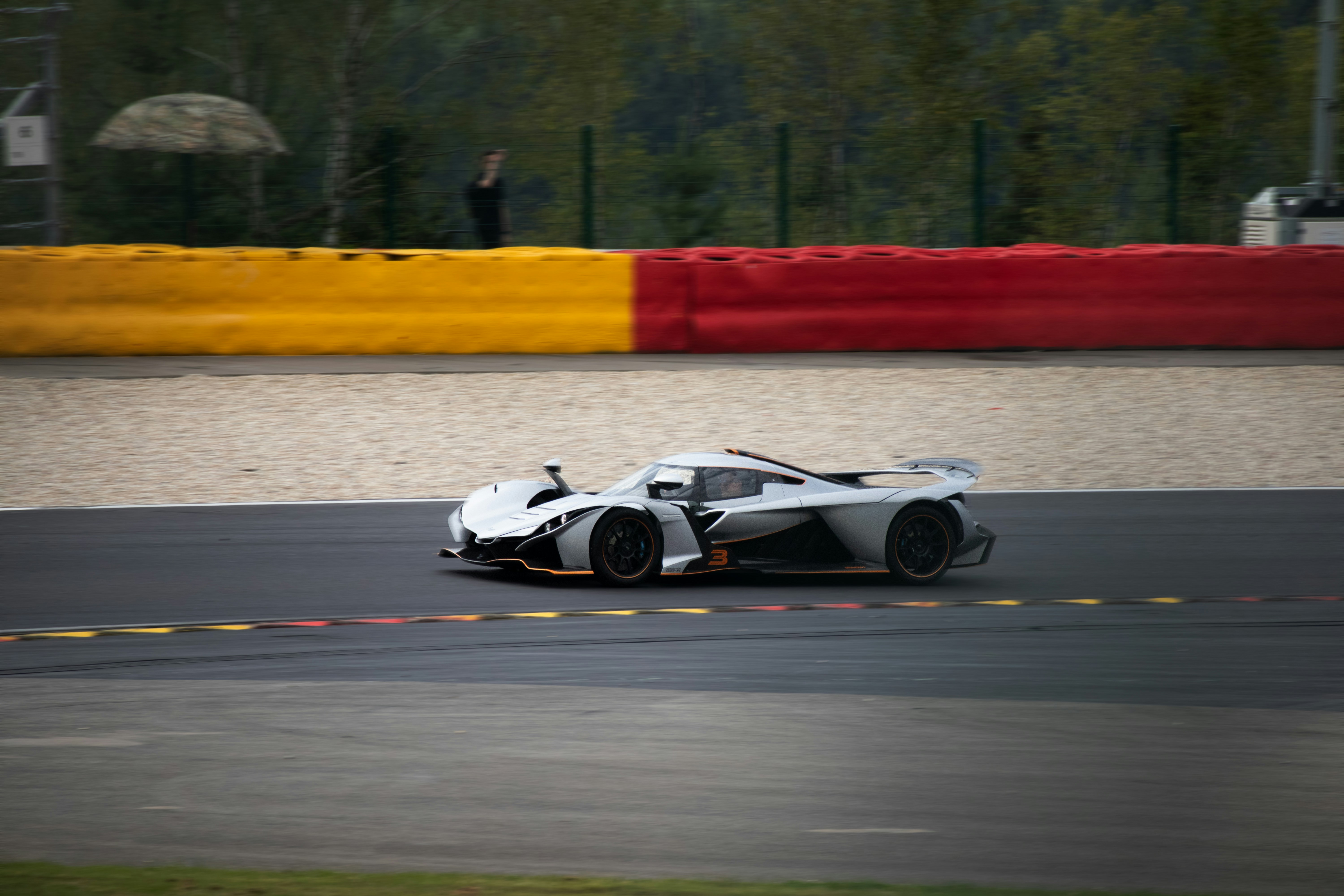 A white race car driving down a race track