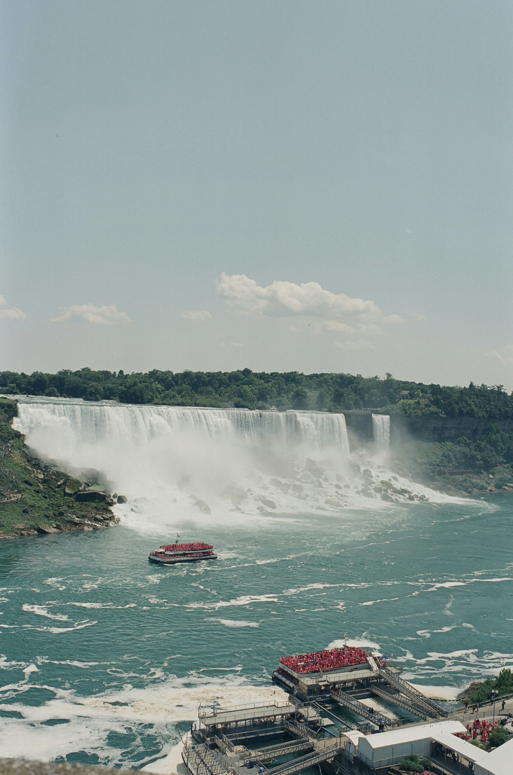 A boat is in the water near a waterfall
