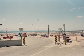 A group of people standing around a parking lot