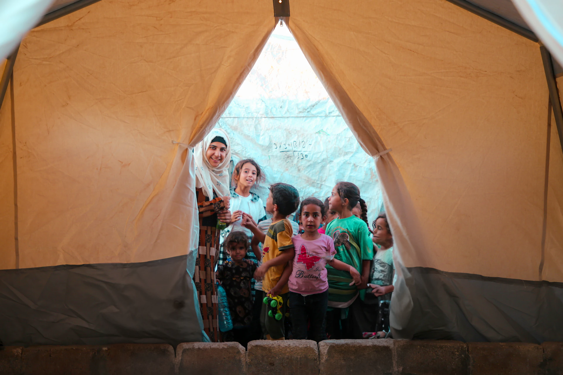 A group of people standing inside of a tent