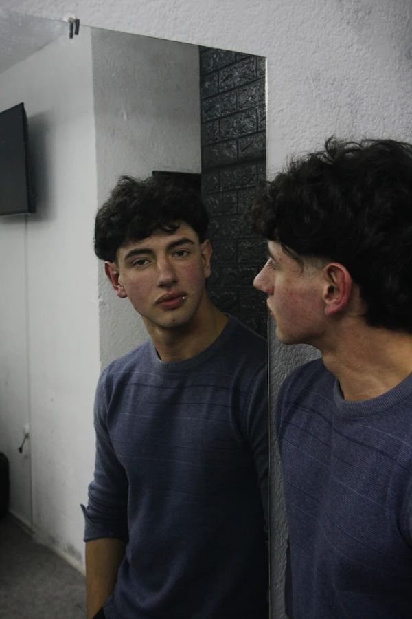A man checking his reflection before heading out