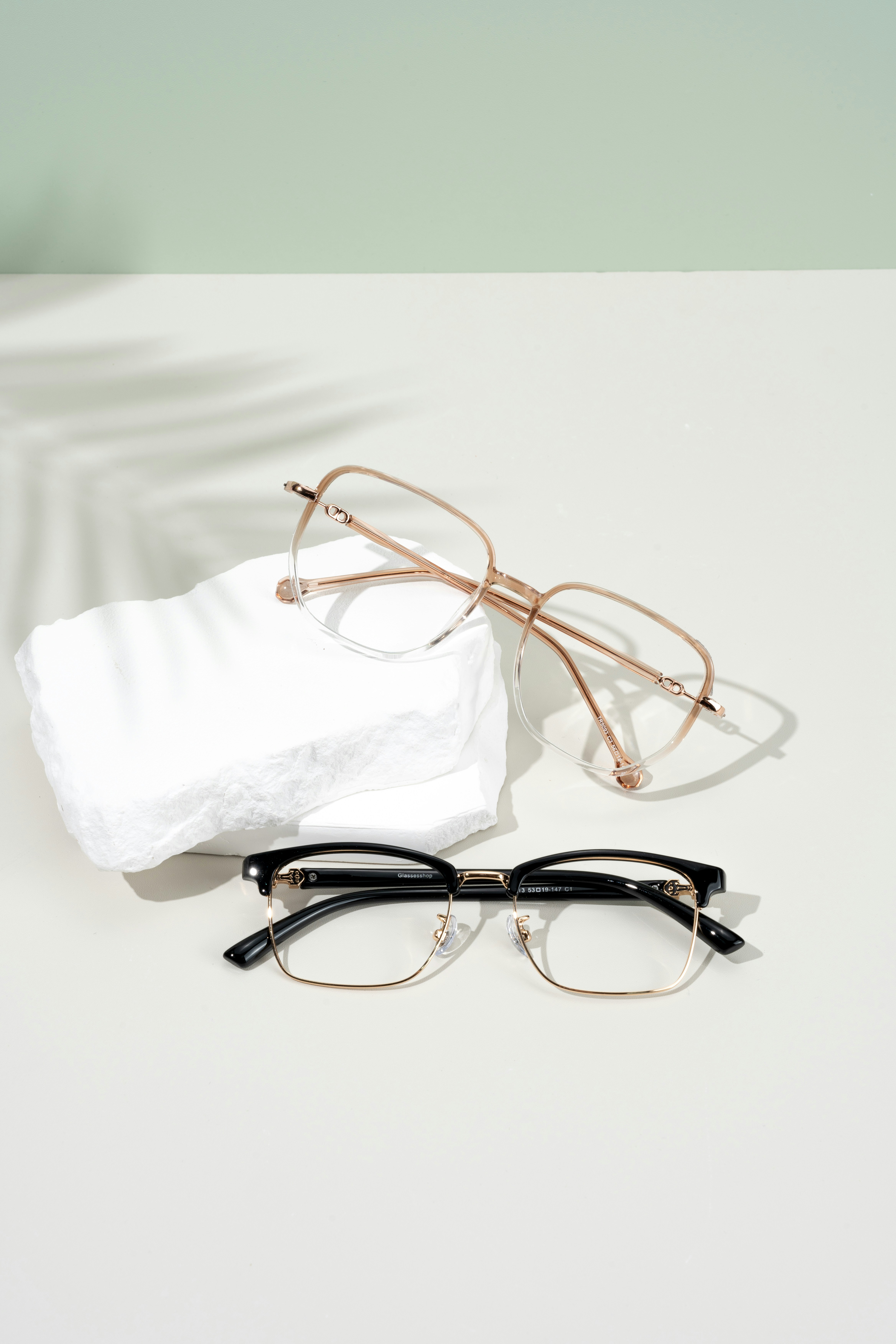 A pair of glasses sitting on top of a white table